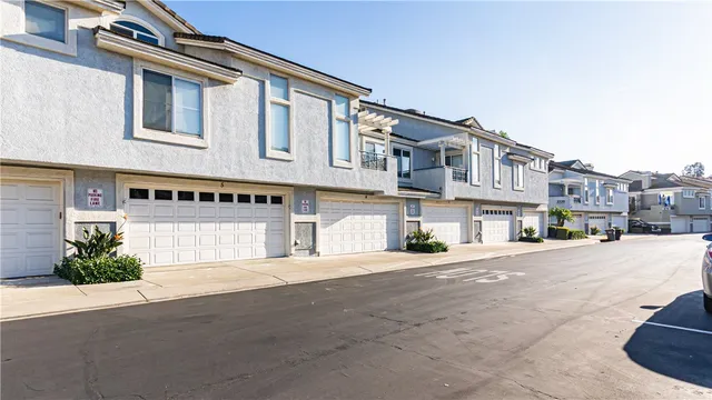a front view of a house with a road