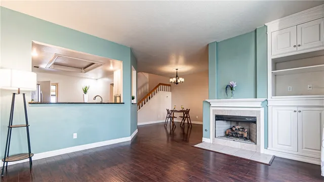 a view of a livingroom with wooden floor and furniture