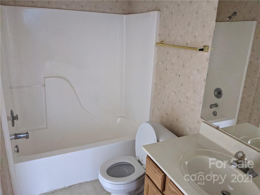 106 Cameron Drive Rutherfordton, NC 28139 - Photo 14 of 19 a white toilet sitting next to a bath tub