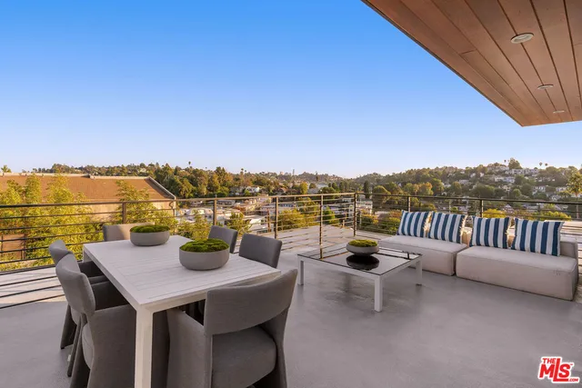a view of a balcony with table and chairs