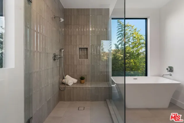a bathroom with a tub and shower