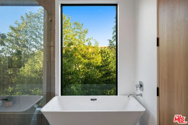 a bathroom with a bathtub and shower