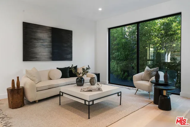 a living room with furniture tv and a large window