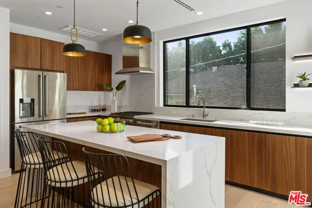 a kitchen with a sink a counter top space and cabinets