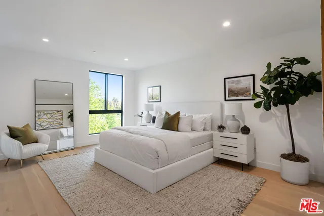 a bedroom with bed and a couch