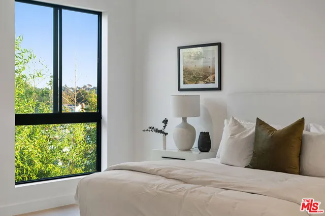 a bedroom with a large bed and a window