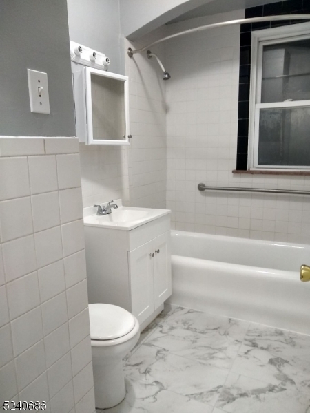 326 Field Place, Unit 2L Hillside, NJ 07205 - Photo 11 of 17 a bathroom with a sink a toilet and shower