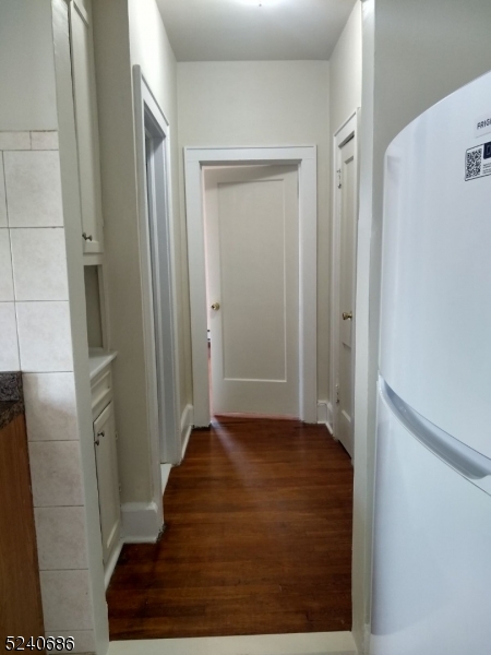 326 Field Place, Unit 2L Hillside, NJ 07205 - Photo 9 of 17 a view of a hallway with wooden floor and staircase