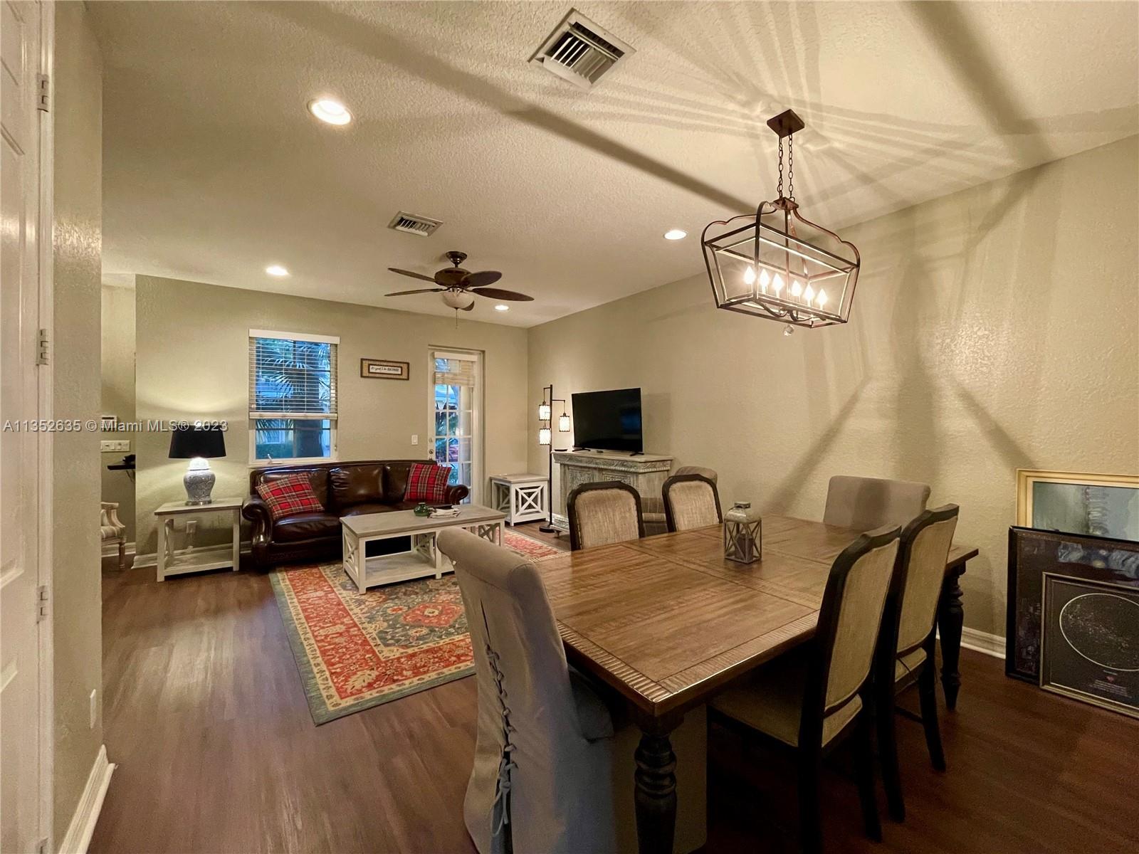 128 Midleton Way Jupiter, FL 33458 - Photo 12 of 39 a living room with furniture and a chandelier