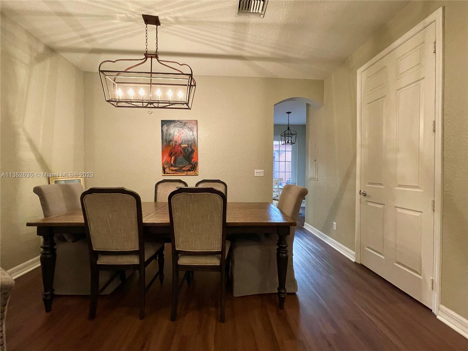 128 Midleton Way Jupiter, FL 33458 - Photo 17 of 39 a view of a dining room with furniture wooden floor and chandelier