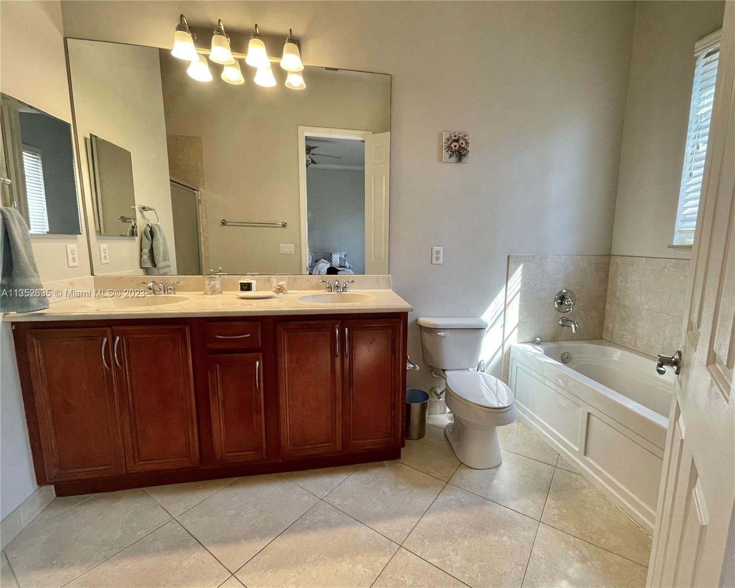 128 Midleton Way Jupiter, FL 33458 - Photo 30 of 39 a bathroom with a sink a toilet and a mirror