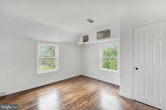 a bedroom with two beds and a large window