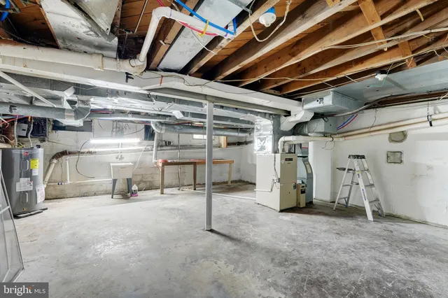 an aerial view of residential houses with outdoor space and trees all around