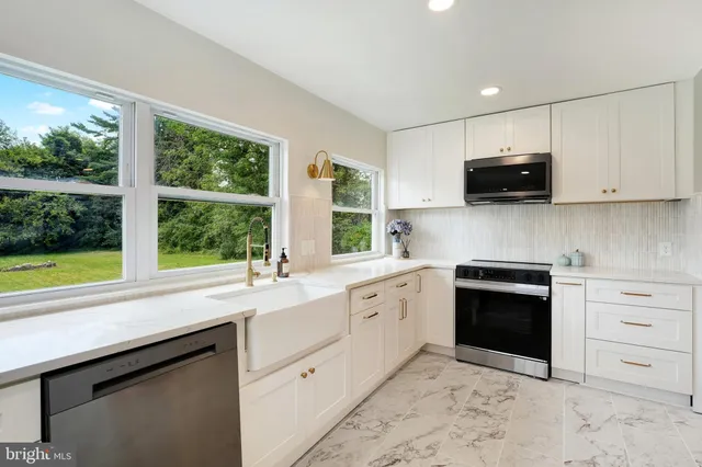 a kitchen with a sink stove and microwave