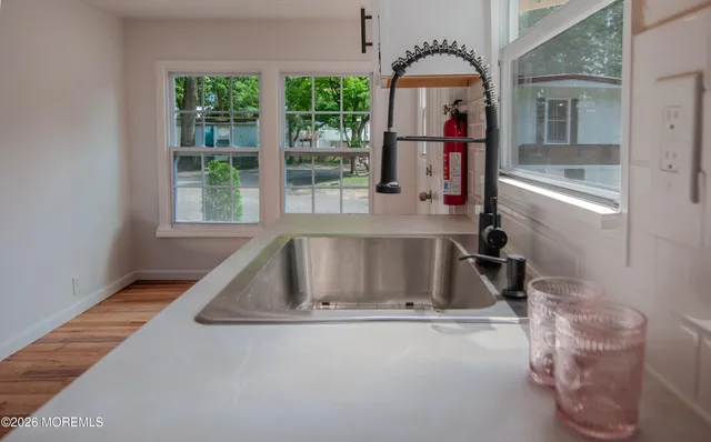 a view of living room with a tub and windows