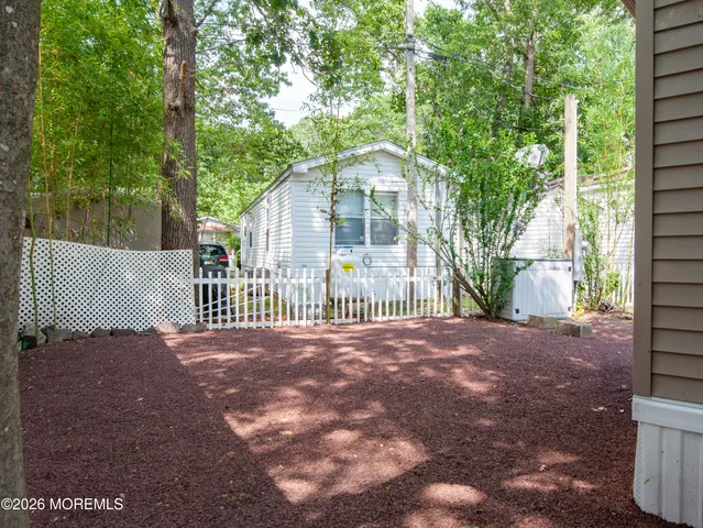 a view of a house with a yard and a porch