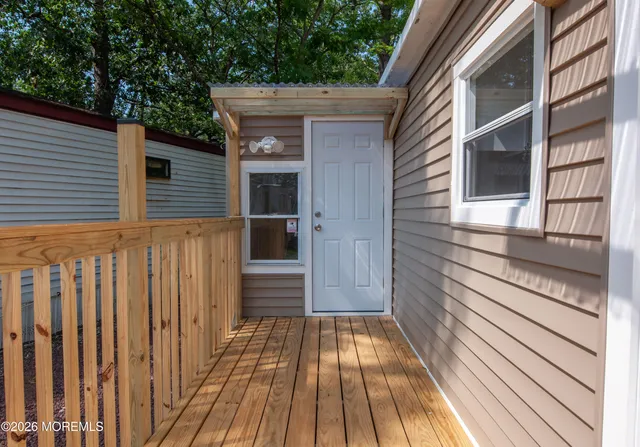 a view of backyard with deck and wooden floor