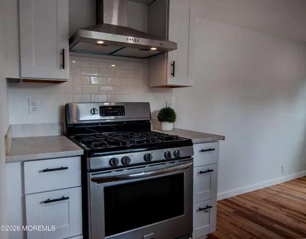 a stove top oven sitting inside of a kitchen