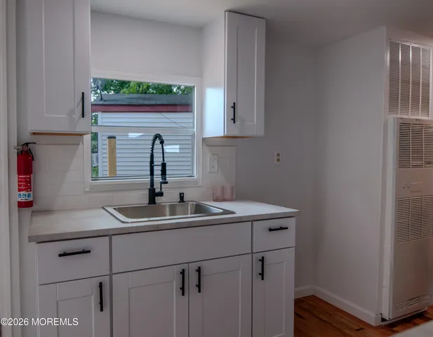 a kitchen with a sink and cabinets