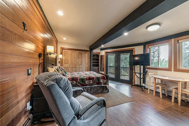 a living room with furniture a wooden floor and chandelier