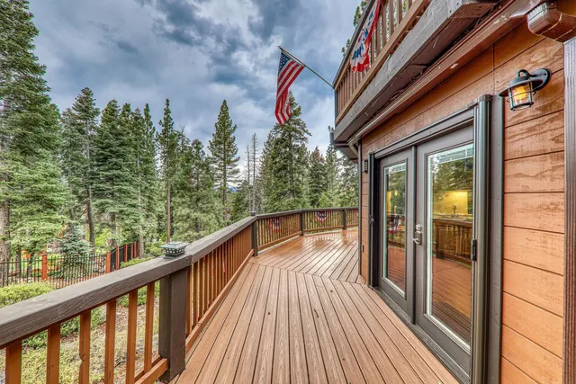 a view of balcony with wooden floor and fence
