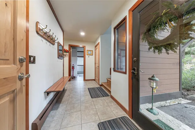 a hallway with painting on the wall and a large mirror