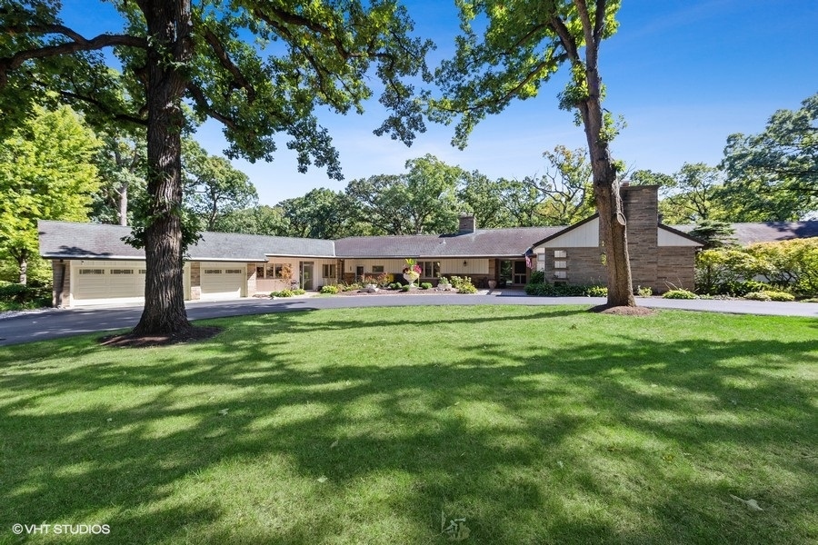 a view of house with backyard space and garden