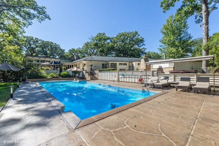 6547 South County Line Road Burr Ridge, IL 60527 - Photo 17 of 24 a view of a patio with swimming pool