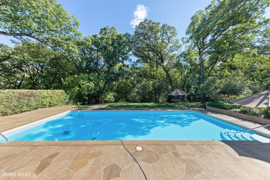 6547 South County Line Road Burr Ridge, IL 60527 - Photo 21 of 24 a view of a swimming pool with an outdoor space