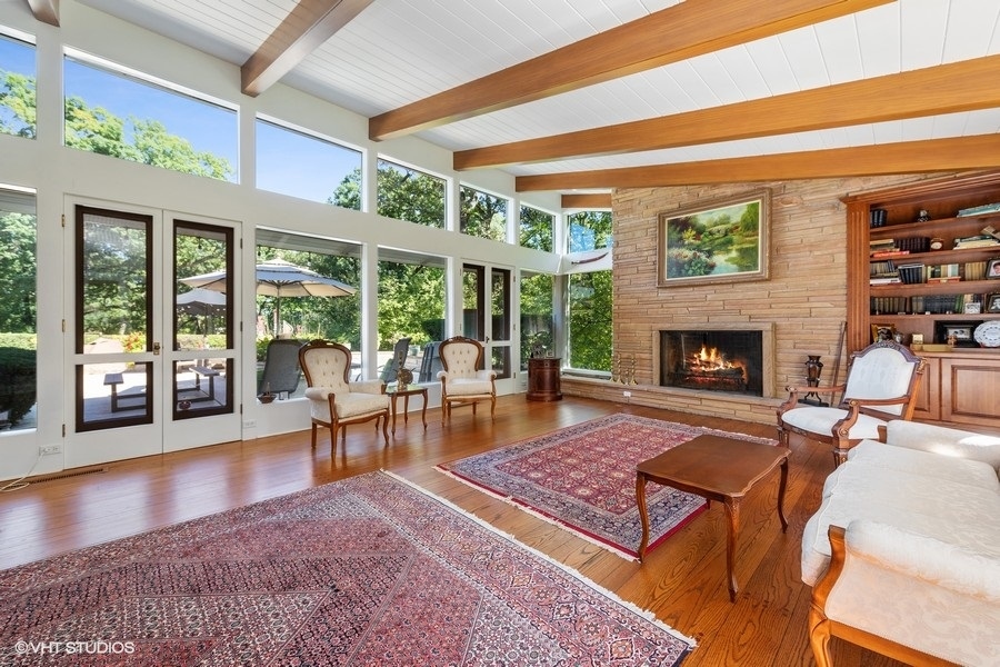 6547 South County Line Road Burr Ridge, IL 60527 - Photo 5 of 24 a living room with furniture a large window and a fireplace