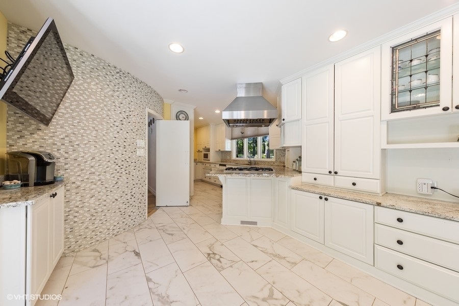 6547 South County Line Road Burr Ridge, IL 60527 - Photo 7 of 24 a kitchen with a sink a stove and cabinets