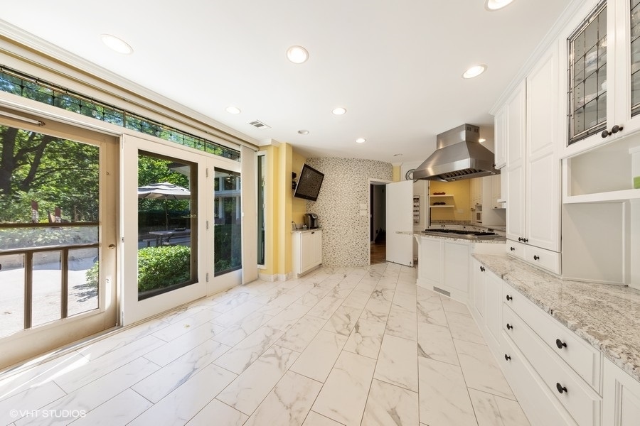 6547 South County Line Road Burr Ridge, IL 60527 - Photo 8 of 24 a view of a kitchen with kitchen island a counter top space a sink and stainless steel appliances
