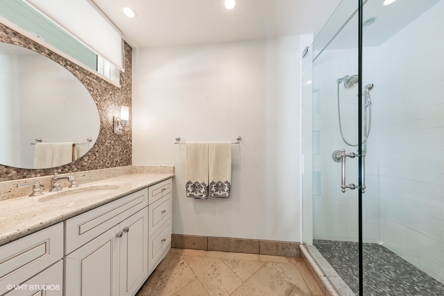 6547 South County Line Road Burr Ridge, IL 60527 - Photo 9 of 24 a bathroom with a granite countertop sink a mirror and a shower