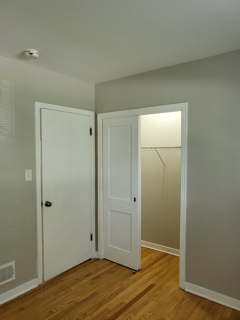 3328 Butler Avenue Steger, IL 60475 - Photo 12 of 22 an empty room with wooden floor and closet area
