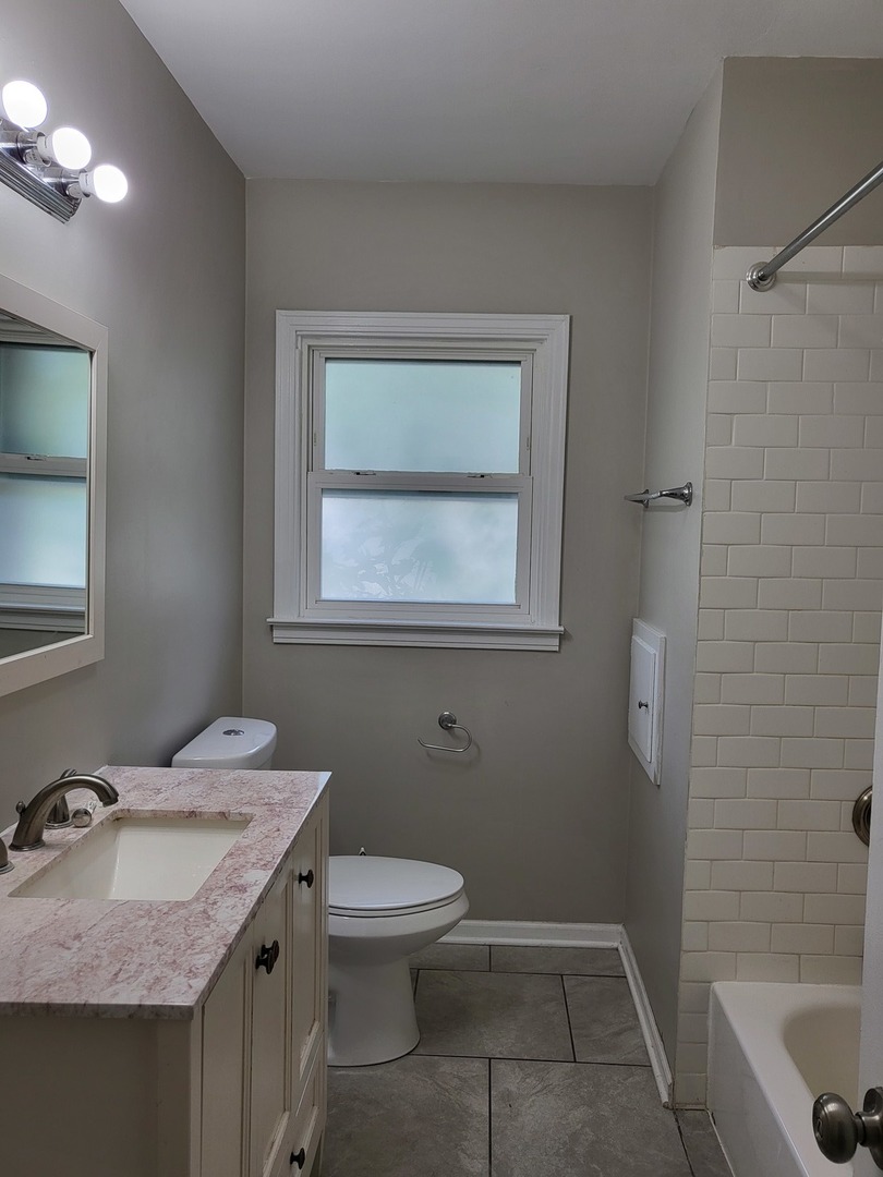 3328 Butler Avenue Steger, IL 60475 - Photo 13 of 22 a bathroom with a granite countertop sink toilet and a mirror