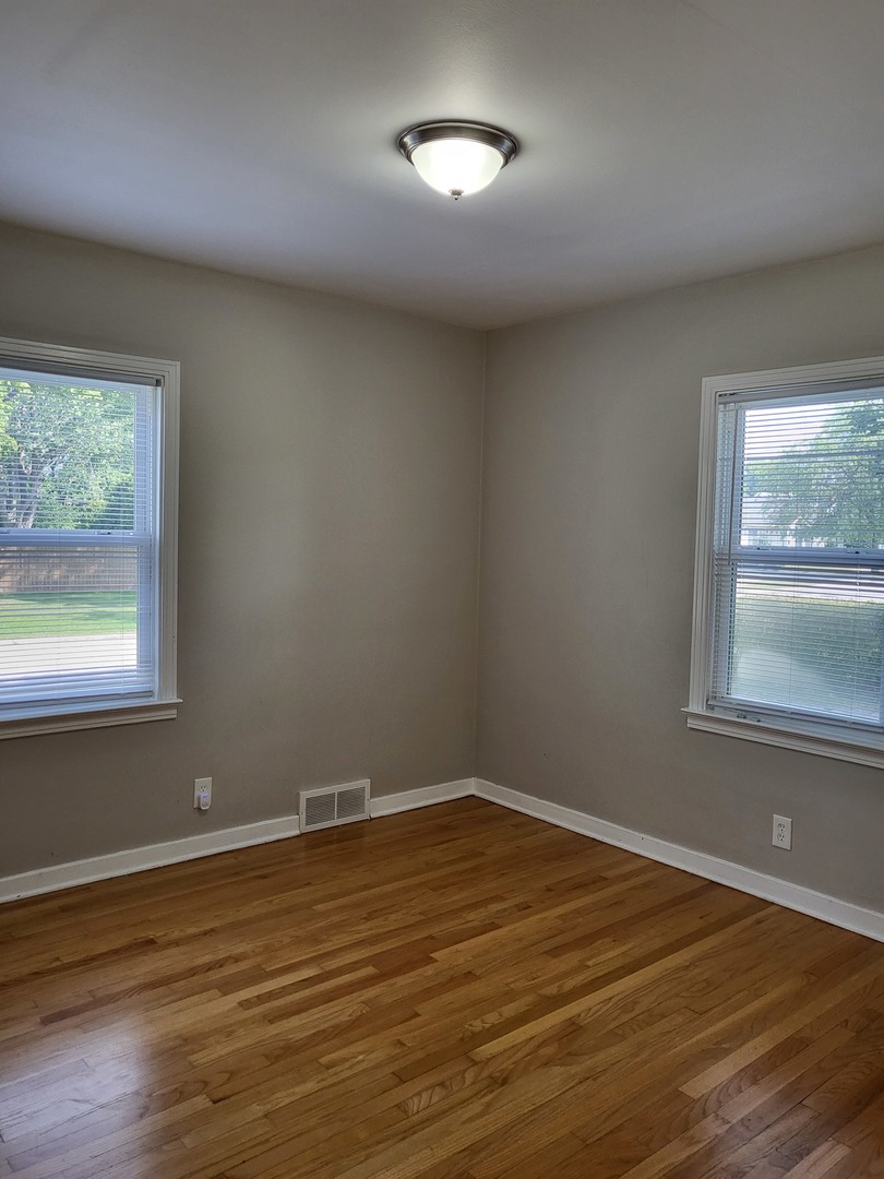3328 Butler Avenue Steger, IL 60475 - Photo 15 of 22 a view of a room with wooden floor and windows