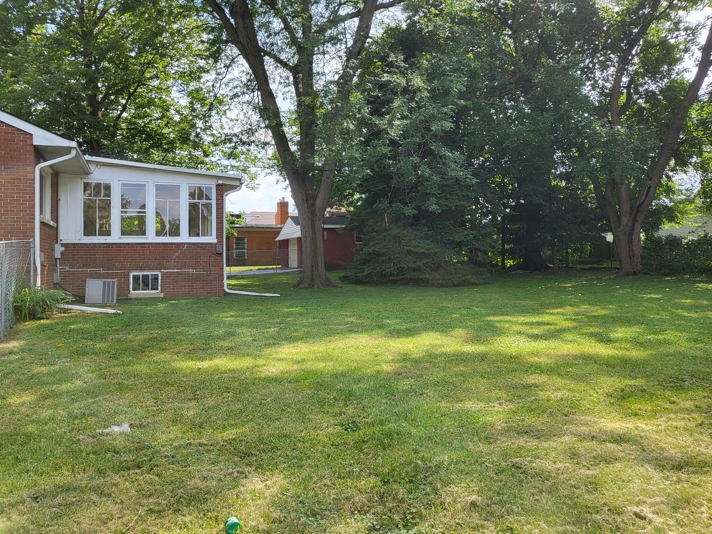 3328 Butler Avenue Steger, IL 60475 - Photo 22 of 22 a front view of house with yard and trees in the background