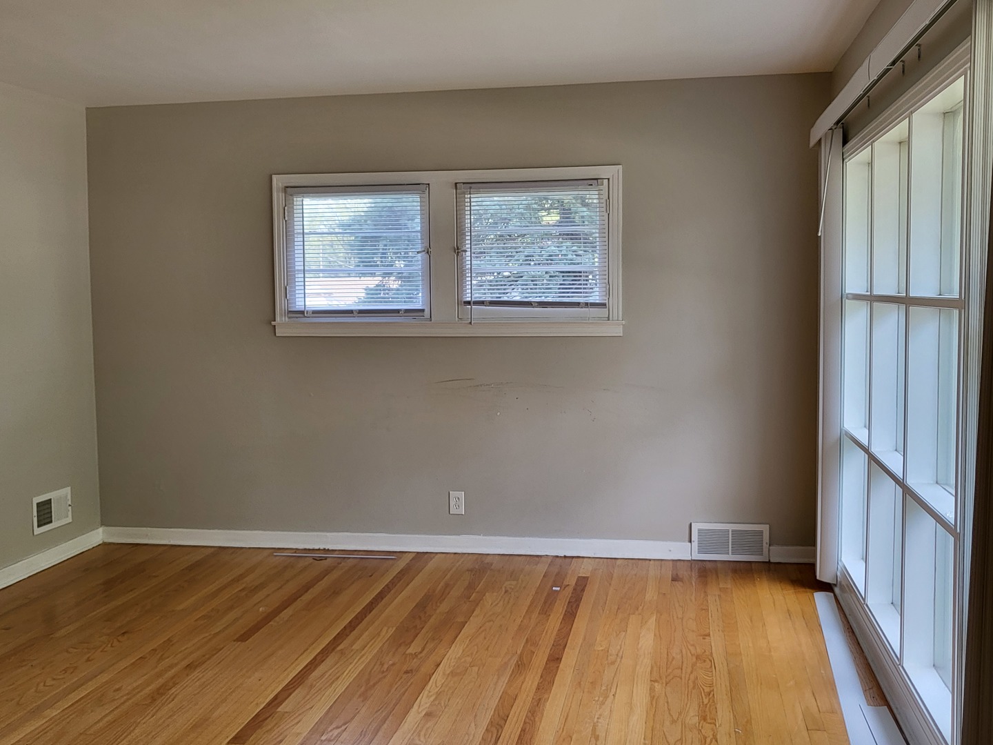 3328 Butler Avenue Steger, IL 60475 - Photo 5 of 22 a view of an empty room with wooden floor and a window