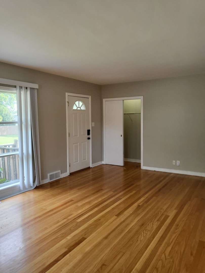3328 Butler Avenue Steger, IL 60475 - Photo 7 of 22 a view of an empty room with wooden floor and a window