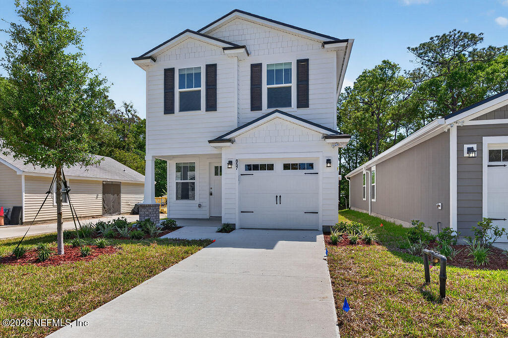 857 Jackson Road Jacksonville, FL 32225 - Photo 1 of 29 a front view of a house with a yard and garage