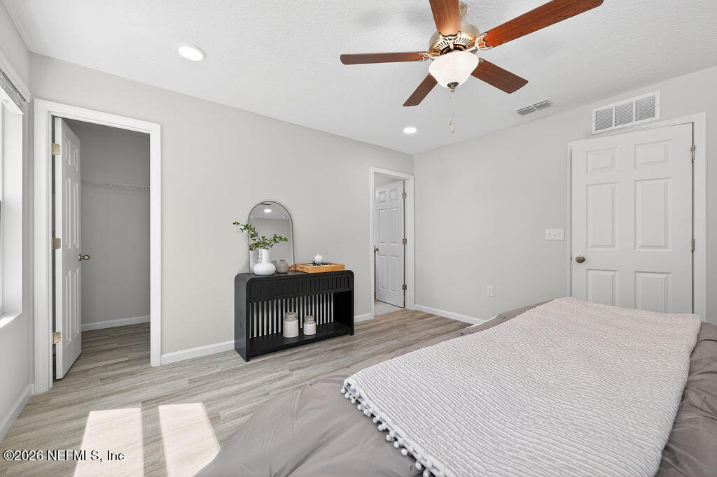 857 Jackson Road Jacksonville, FL 32225 - Photo 18 of 29 a bedroom with a bed and a chandelier