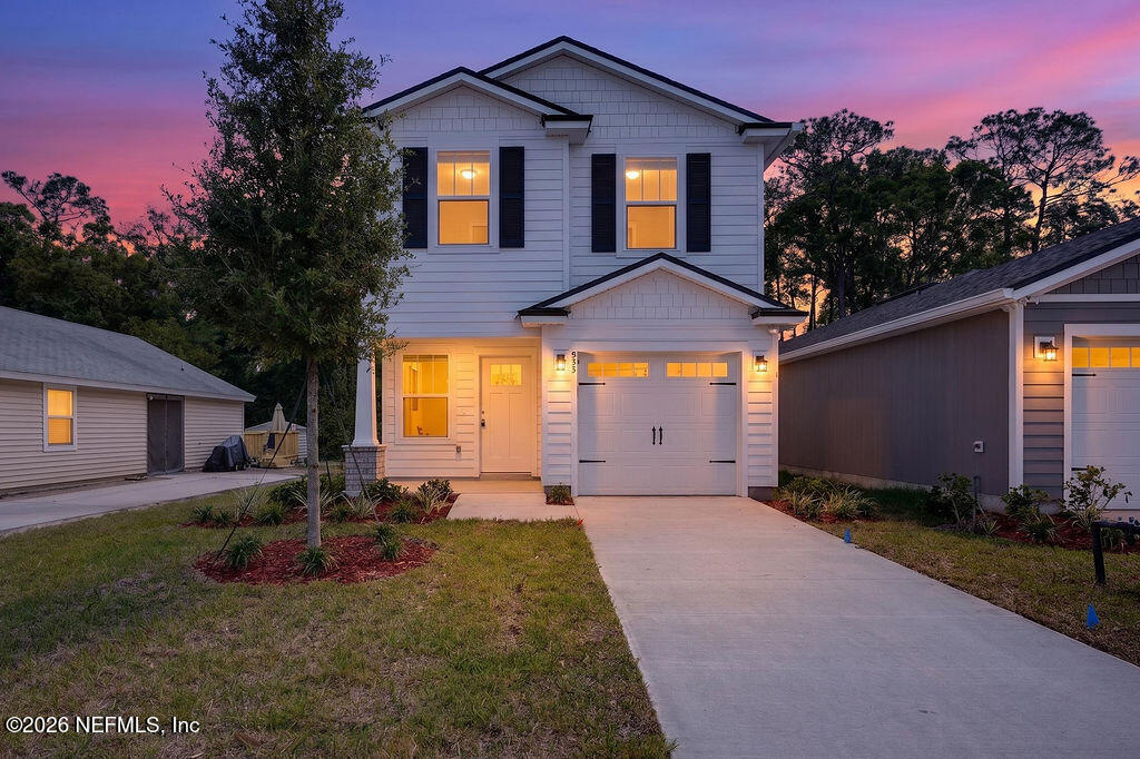 857 Jackson Road Jacksonville, FL 32225 - Photo 2 of 29 a front view of a house with a yard and garage