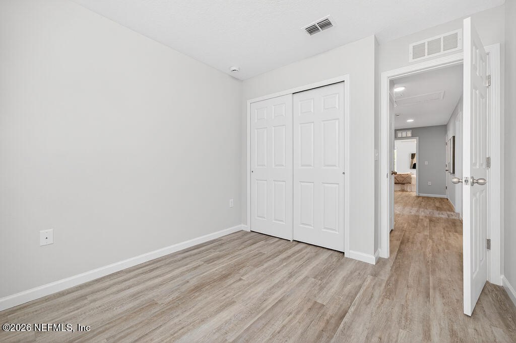 857 Jackson Road Jacksonville, FL 32225 - Photo 26 of 29 wooden floor in an empty room