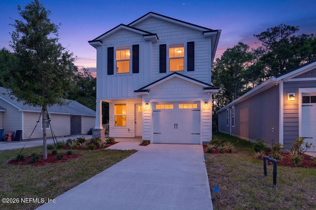 857 Jackson Road Jacksonville, FL 32225 - Photo 29 of 29 a front view of a house with a yard and garage