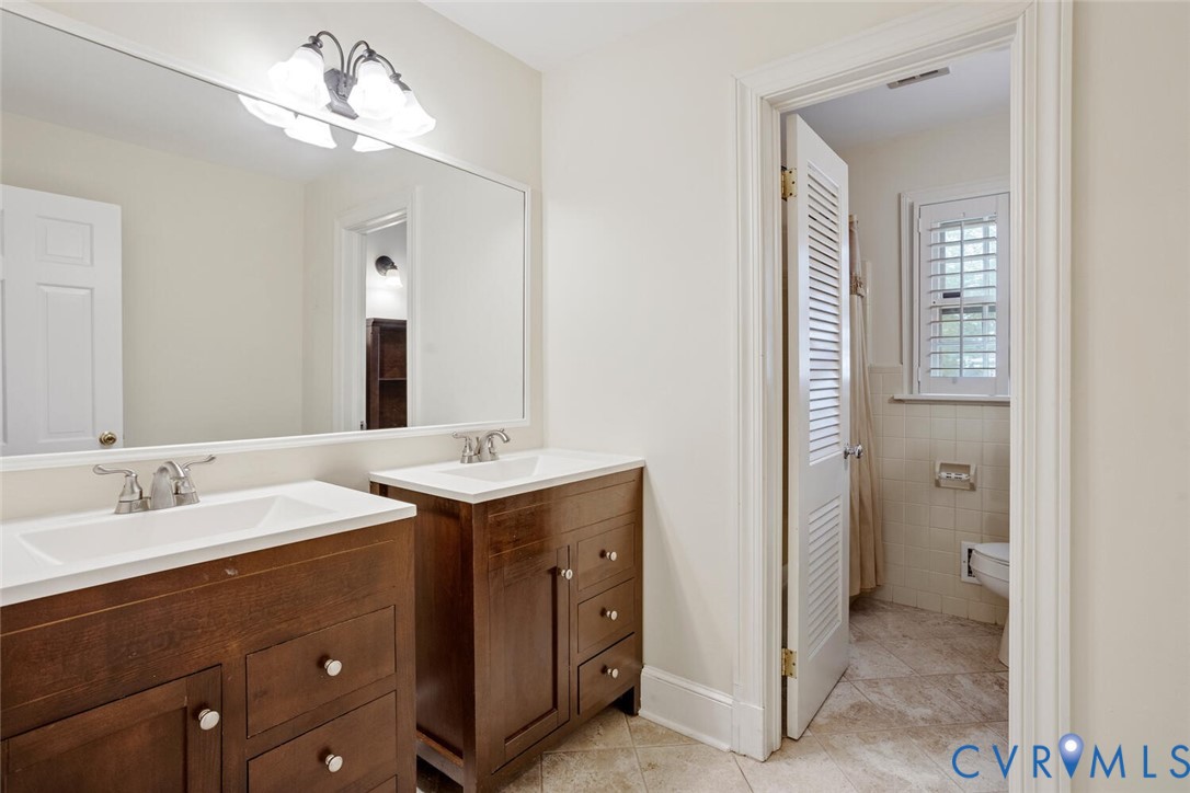 307 North Wilkinson Road Richmond, VA 23227 - Photo 25 of 48 Full bathroom featuring two vanities and tile patt