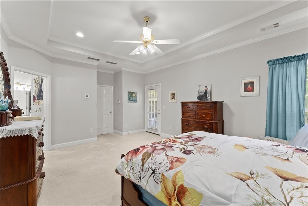 1617 Edwards Mill Road Ball Ground, GA 30107 - Photo 12 of 42 a bedroom with a large bed and a chandelier