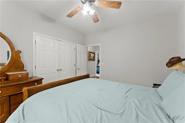 a spacious en suite bathroom with double sink a toilet a window and a mirror