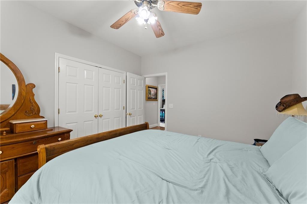 1617 Edwards Mill Road Ball Ground, GA 30107 - Photo 18 of 42 a bedroom with a bed and a chandelier