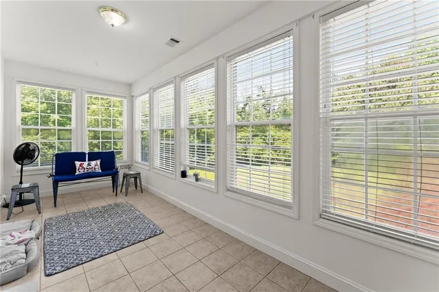 a living room with lots of furniture and clutter