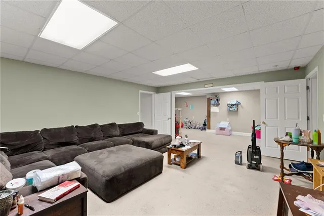 a view of a livingroom with workspace and a window